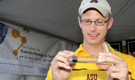 An instructor plays with a tube of ferro-fluid